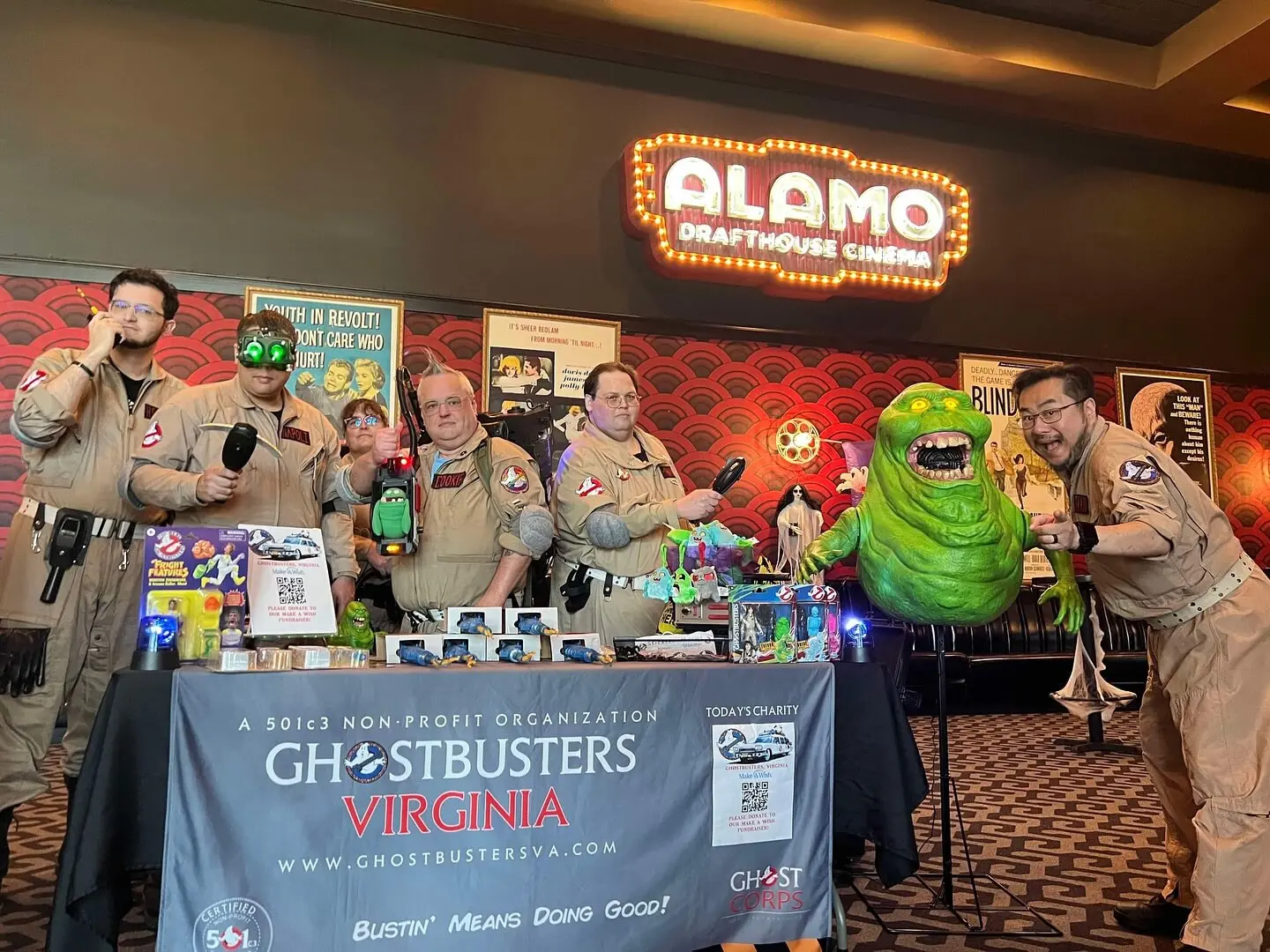 Ghostbusters Virginia members at an Alamo Drafthouse Cinema event with Slimer prop and franchise banner