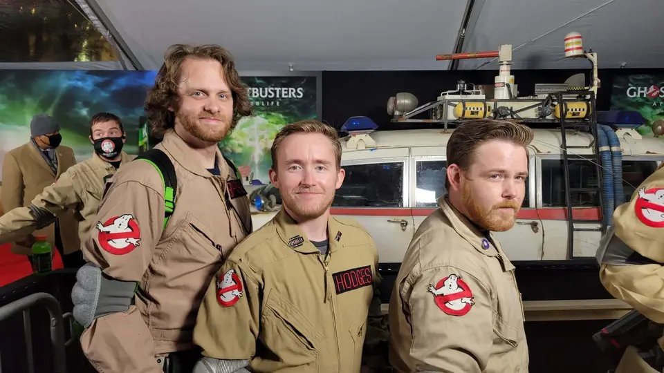 Three Ghostbusters Virginia members in full uniforms posing at a movie premiere event