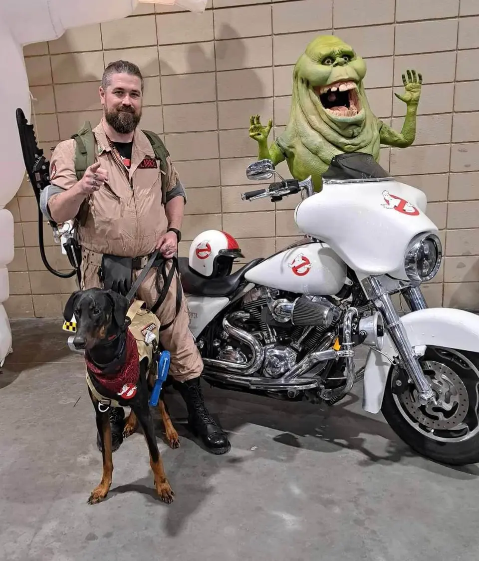 Ghostbusters Virginia members in full gear posing with the Ecto vehicle