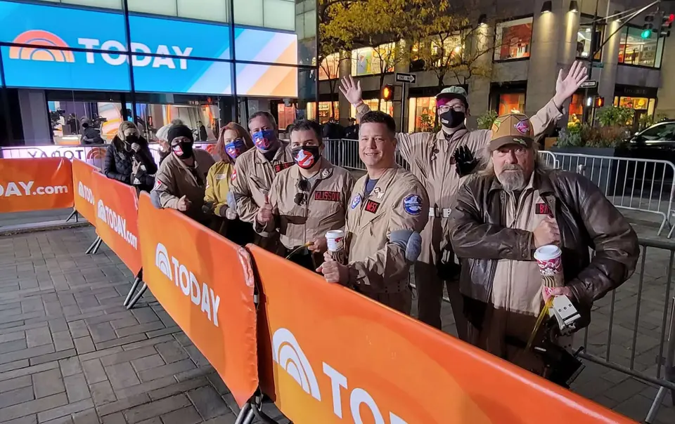 Ghostbusters Virginia members waving behind orange barriers at a TODAY show appearance